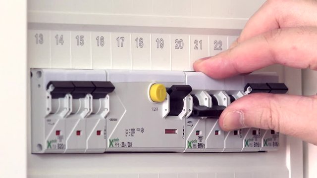 Person's Hand Repair Turn On The Switchboard. Static closeup shot.
