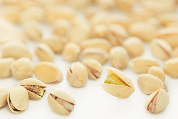 The pistachios on white background. The pistachio background.