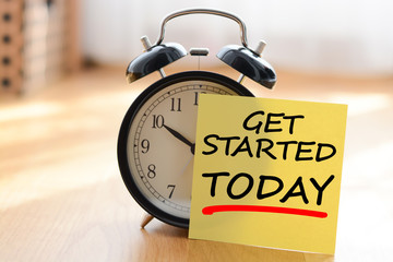 Start today your own business concept with alarm clock and post it message