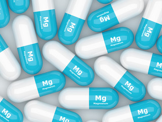 magnesium pills lying on white table - obrazy, fototapety, plakaty