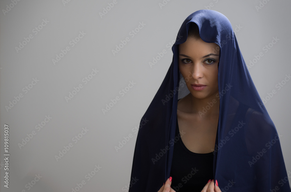 Wall mural Woman in blue veil