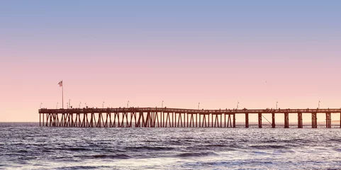 Wall murals Pier Vintage toned long wooden pier at sunset.
