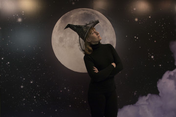 Witch, moon and clouds at night on Halloween