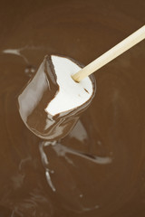 cream spilling on melted chocolate