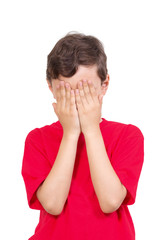 Fototapeta premium Young boy covering his eyes isolated on white background 