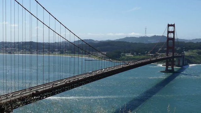 Golden Gate Bridge windy hilltop time lapse view with zoom out in San Francisco, California.