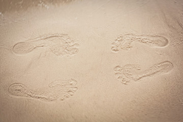 Loving couple legs sand prints. Leg print on the sand beach 