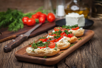 Delicious bruschetta with tomatoes, feta cheese, dill and spice