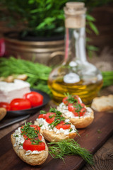 Delicious bruschetta with tomatoes, feta cheese, dill and spice
