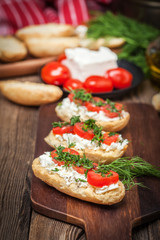 Delicious bruschetta with tomatoes, feta cheese, dill and spice