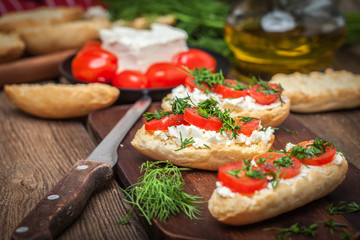 Delicious bruschetta with tomatoes, feta cheese, dill and spice