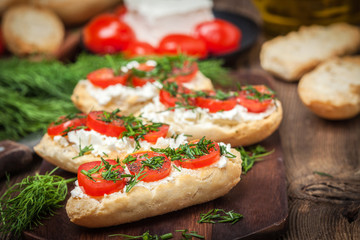 Delicious bruschetta with tomatoes, feta cheese, dill and spice