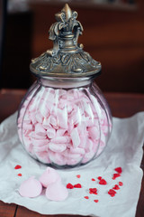 marshmallows in a glass jar on wooden table