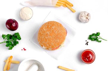 Burger topped with vegetables, spices and fries