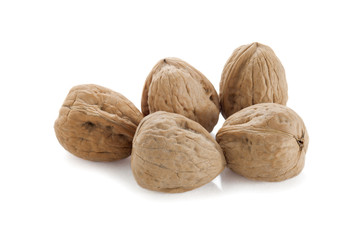 five walnuts on a white background