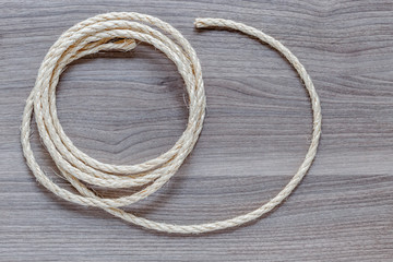 rope coiled on a wooden table