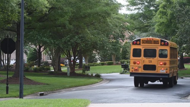 School bus driving thru a neighborhood