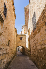 Ancient alley with arc in Baeza