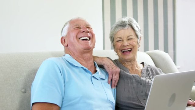  Happy senior couple using a computer