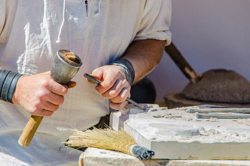 Unrecognizable man working with chisel