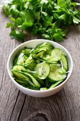 Cucumber salad on wooden background