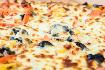 Italian Pizza With Mozzarella, Prosciutto, Tomatoes And Olives