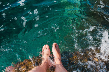 Two feet dipping  in water.Foot spa. Relax