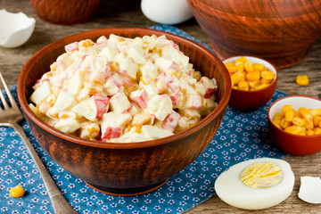 Corn salad with egg and crab and ingredients in a rustic style