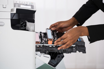 Businesswoman Hand Fixing Photocopy Machine