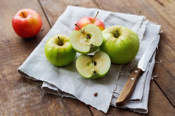 Healthy snack background - red and green apples on rustic wooden background.