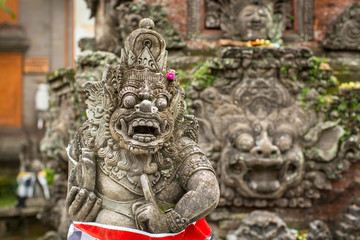 Fototapeta premium Traditional demon guard statue carved in stone on Bali island, Indonesia.
