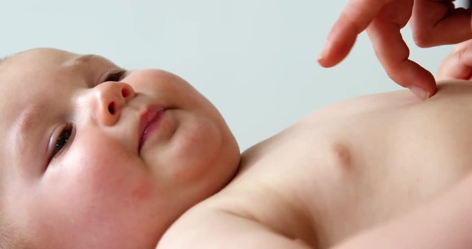 Close up someone touching carefully a baby
