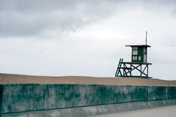 Stunning isolated beach scene, featuring a lifeguard tower and sand dunes.
