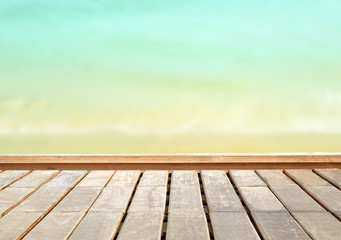 Fototapeta na wymiar wooden floor with sea and sky blurred background