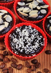 Chocolate muffins with desiccated coconut and almonds, coffee grains