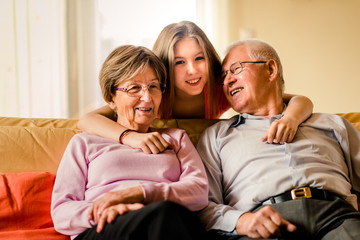 Fototapeta na wymiar Grandchild with grandparents at home