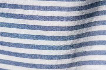 Textile background from a fabric with blue and white stripes