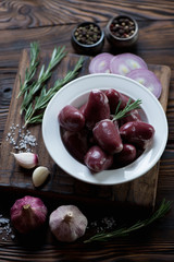 Plate with raw turkey hearts and seasonings, selective focus