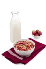 cereals, strawberry and a bottle of milk