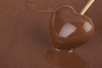 heart in a stick dipped in melted chocolate