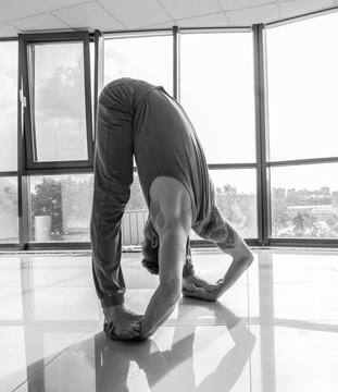 Athletic muscular young man working out, yoga