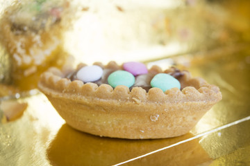 pastry with chocolate cream and colored comfit