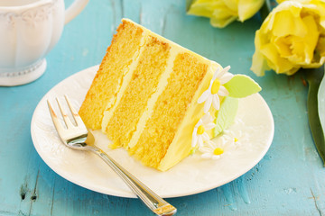 A piece of lemon sponge cake on a plate.