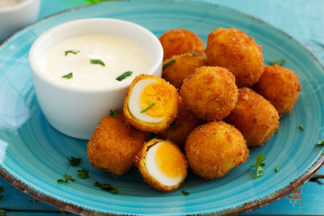Quail eggs, deep fried with white sauce.