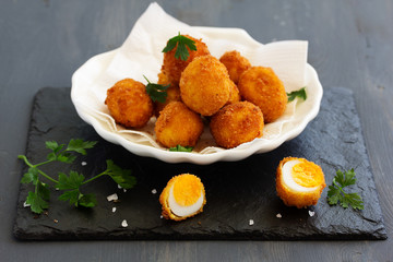 Quail eggs, deep fried with white sauce.
