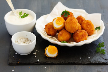 Quail eggs, deep fried with white sauce.