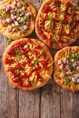 hot langos with cheese, ketchup and ham close-up. vertical top view
