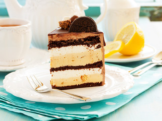 Homemade cake with chocolate, peanuts and caramel, decorated with candies and marshmallows.