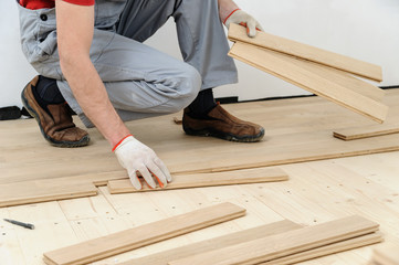 Laying hardwood parquet.