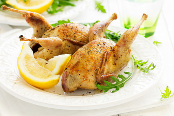 Delicious fried quail with herbs and greens.